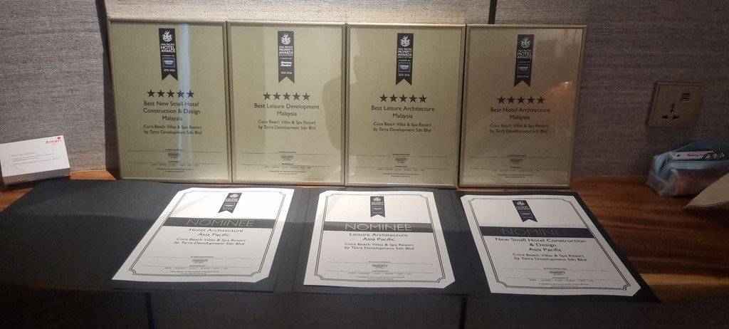 The four framed Malaysia winner plaques and three Asia Pacific nominee certificates from the Asia Pacific Property Awards 2025–2026